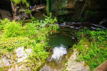 Caglieron, Italy - May 26, 2019: group of tourists at hiking trail in caves