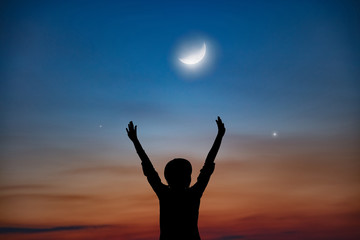 Woman enjoying starry night with arms wide open.