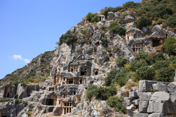 Fototapeta na wymiar A magnificent view of the stone crypts and caves in the rocks in the ancient city of Demre, Turkey.