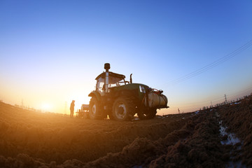 Fototapeta premium The tractor in farmland farming