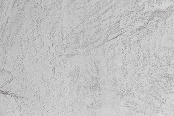 exture of concrete and plaster on the wall. Lines in the plaster. Texture of decorative plaster or stucco close up, abstract gray background.