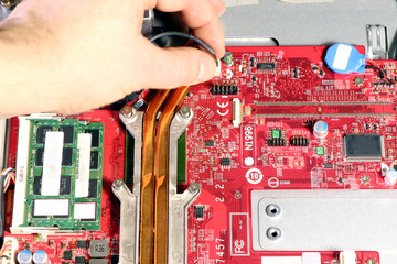 Fixing mothe board. Computer mother board with chip components and cooling system. Inside personal...