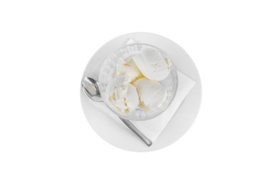 four balls Ice cream dessert, vanilla flavor, isolated on a white background in creamer on a plate with a spoon and a napkin, view from above for menu