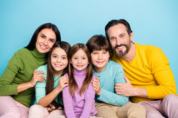 Fototapeta premium Close-up portrait of nice attractive careful affectionate friendly ideal cheerful cheery adorable family embracing enjoying holiday isolated on bright vivid shine vibrant blue color background