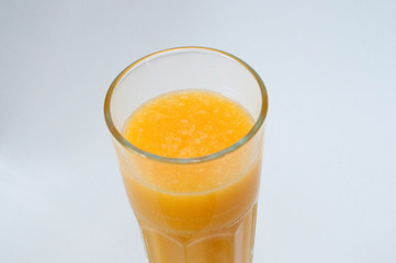 Orange juice glass, isolated on white background, closeup view from the top