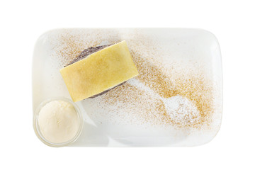 poppy seed cake, charlotte with vanilla ice cream, served on a plate isolated white background, pattern cinnamon. Dessert for a menu in a cafe, restaurant, coffee shop, view from above