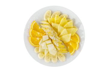 Plate with different sliced fruit plates isolated white background, sprinkled with powdered sugar. Dessert for a menu in a cafe, restaurant, coffee shop view from above