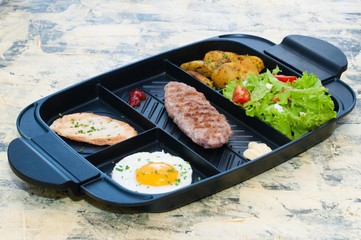 Breakfast, fried steak or cutlet, salad with tomato and green vegetables, croutons, potatoes, egg side view, light background. The concept of healthy diet, diet, menu, good nutrition.