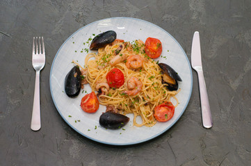 Spaghetti pasta with shrimp, mussels, tomatoes and cheese. Tasty, traditional Italian food
