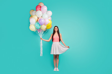 Full body photo of charming elegant pretty girl hold many air baloons she get present on spring time anniversary wear good look singlet shoes isolated pastel turquoise color background