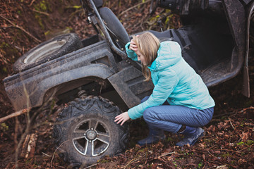 Woman shocked by an estremal ride on UTV. Checks the status of a buggy that has rolled down a mountain into a ditch. Extreme ATV Riding