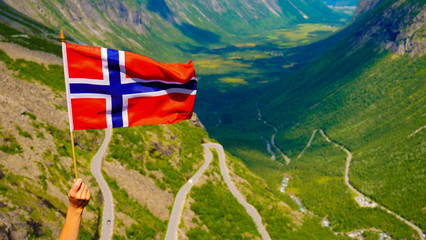 Norwegian flag and Trollstigen mountain road