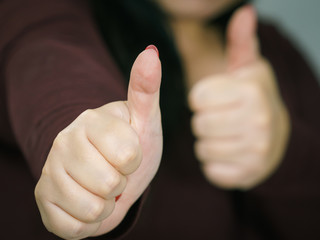 Woman making thumb up gesture