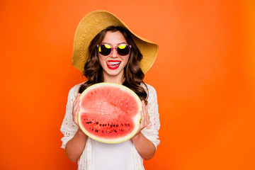 Photo of cheerful cute nice casual charming positive attractive student licking lips red holding big half of water melon isolated over vivid orange color background