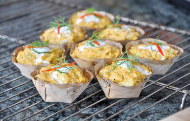 close up of Thai traditional food Hor mok can be made with fish or chicken with coconut cream,red chili paste, basil leaves and streamed in banana leaves.