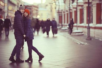 young man and woman hugging kissing outside
