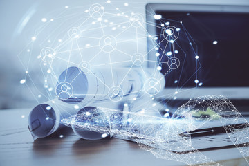 Computer on desktop with social network theme icon. Multi exposure. Concept of international connections.