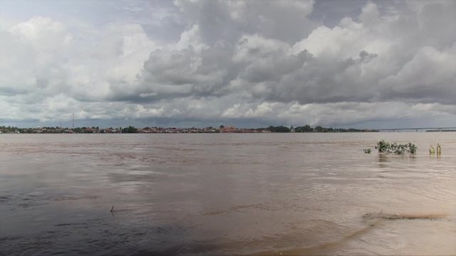 Rising water level of river during the monsoon under dark clouds skies