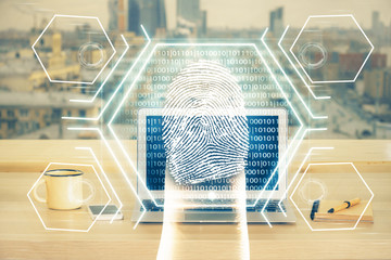 Computer on desktop in office with finger print drawing. Double exposure. Concept of business data security.