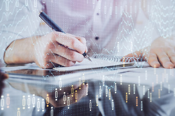 Multi exposure of man planing investment with stock market forex chart.