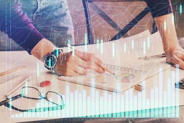 Financial trading chart double exposure with man desktop background.