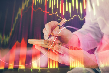 Double exposure hands with stock market chart.
