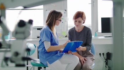 A woman has a dental check-up in dentist surgery. - Powered by Adobe