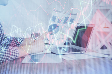 Multi exposure of financial graph with man works in office on background. Concept of analysis.