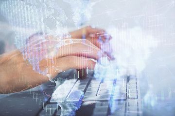 Multi exposure of graph with man typing on computer in office on background. Concept of hard work....