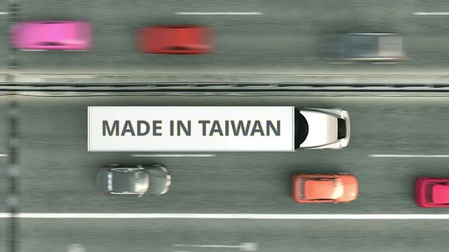 Aerial overhead view of trailer trucks with MADE IN TAIWAN text driving along the road. Taiwanese business related loopable 3D animation