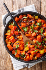 fried sweet potato black bean chili close-up in a pan. Vertical top view