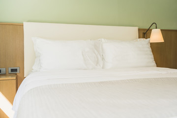 White comfortable pillow on bed decoration interior