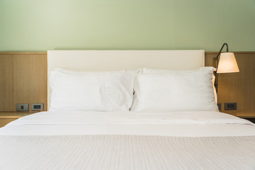 White comfortable pillow on bed decoration interior
