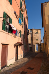 Fototapeta na wymiar Colourful old-fashioned façade the houses in Imperia old town - the city in Liguria region of Italy