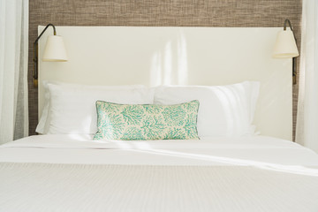 White comfortable pillow on bed decoration interior