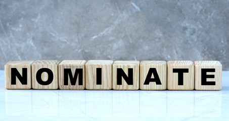 concept word nominate on cubes on a beautiful gray background