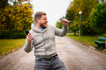 Young man dancing autumn in the park