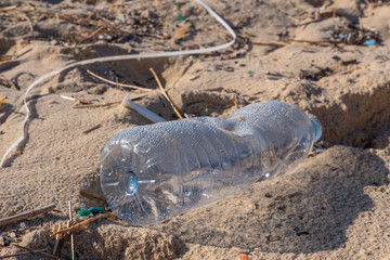 Plastic bottle on the beach, pollution
