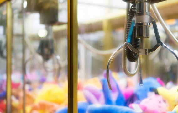 Mechanical claw game machine. Close-up view.