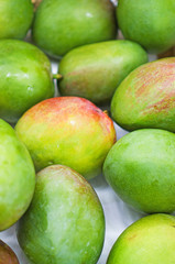 Close-up view of organic mangoes in supermarket.