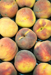 Close-up view of organic peaches in supermarket.