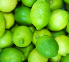 Close-up view of organic limes in the basket.