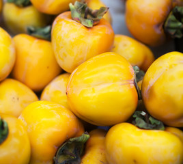 Close-up view of organic persimmons in supermarket.
