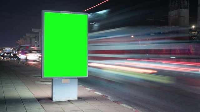 Timelapse advertising billboard on street at night with traffic