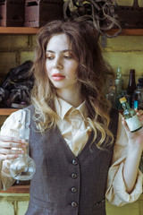 Beautiful girl chemist mixes drugs.