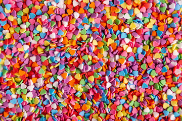 Fototapeta na wymiar Colorful heart candies in flat lay
