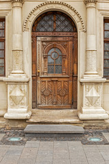 Fototapeta na wymiar Old wooden authentic door on Rynok Square, Lviv city. Old authentic door of Lviv city.