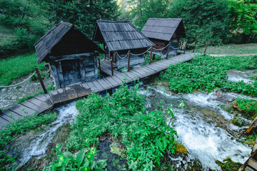 Picturesque old small wooden water mills by the Pliva lakes in Jajce, Bosnia and Herzegovina.