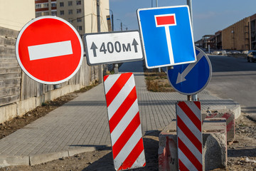 Work in progress. Roadworks, road signs. Men at work. Some signs signage for work in progress on...