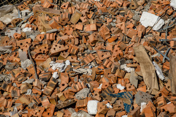 Construction waste, concrete debris from the demolition, road. Construction waste is piled up at site after building repair. Removal of debris.